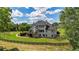 Expansive backyard featuring a large, well-maintained lawn, black fence, and outdoor deck at 104 Meadow View Trl, Canton, GA 30115