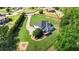 Aerial view of a two-story home with a spacious backyard, deck, landscaping, and fire pit area at 104 Meadow View Trl, Canton, GA 30115