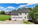 Spacious three-car garage with a basketball hoop, plus a well manicured lawn and established landscaping at 104 Meadow View Trl, Canton, GA 30115