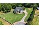 Beautiful two-story home on a sprawling, manicured lawn with a long driveway and fenced yard at 104 Meadow View Trl, Canton, GA 30115