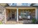 Charming front porch adorned with stone, seating and stylish decor, creating a cozy entrance at 104 Meadow View Trl, Canton, GA 30115