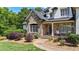 Home featuring a stone facade, manicured landscaping, and a welcoming walkway leading to the front door at 104 Meadow View Trl, Canton, GA 30115