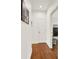 Hallway with wood floors and white walls, leading to another room with a glimpse of a dresser at 104 Meadow View Trl, Canton, GA 30115