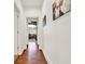 Hallway with hardwood floors and white trim lead to a living area with natural light at 104 Meadow View Trl, Canton, GA 30115