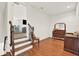 The stairway landing gives way to the hardwood floors of the front hallway that features a side table and bureau at 104 Meadow View Trl, Canton, GA 30115
