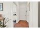 Hallway with hardwood floors leading to a laundry area with white door at 104 Meadow View Trl, Canton, GA 30115