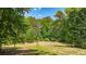 View of cleared land lot surrounded by lush green forest of trees in a serene setting at 104 Meadow View Trl, Canton, GA 30115