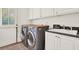 Bright laundry room with front loading washer and dryer and convenient utility sink at 104 Meadow View Trl, Canton, GA 30115