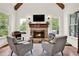 Cozy living room with stone fireplace, wood beams, and large windows at 104 Meadow View Trl, Canton, GA 30115