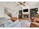 Inviting living room with fireplace, built-in bookcases, and staircase at 104 Meadow View Trl, Canton, GA 30115