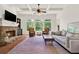 Living room with stone fireplace, built in shelves and large windows offering natural light and beautiful wooded views at 104 Meadow View Trl, Canton, GA 30115
