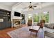This living room has a stone fireplace, built-in shelving, and floor to ceiling windows with wooded views at 104 Meadow View Trl, Canton, GA 30115