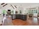 Open-concept layout with a kitchen island, fireplace, and a dining area, seamlessly connected at 104 Meadow View Trl, Canton, GA 30115