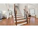 Elegant staircase with wood steps and iron railing connects multiple levels of the home at 104 Meadow View Trl, Canton, GA 30115