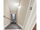 Staircase leading to basement is lit by a wall light and provides access to the basement area at 104 Meadow View Trl, Canton, GA 30115