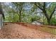Expansive wooden deck perfect for outdoor entertaining, overlooking a lush, wooded backyard and detached garage at 2205 Stockbridge Se Dr, Atlanta, GA 30316