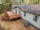 Rear exterior of home with a large deck accessible by stairs, overlooking a wooded backyard at 2205 Stockbridge Se Dr, Atlanta, GA 30316