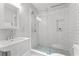 Modern bathroom with white subway tile shower, glass door, and pedestal sink at 2205 Stockbridge Se Dr, Atlanta, GA 30316