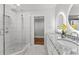 Modern bathroom with tile shower, dual vanity, granite counter tops, and decorative mirror at 2205 Stockbridge Se Dr, Atlanta, GA 30316
