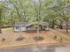 Charming house nestled among mature trees with a welcoming front porch and attractive landscaping at 2205 Stockbridge Se Dr, Atlanta, GA 30316