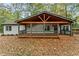 Charming home featuring a covered porch with wood beams and ample natural light and an inviting entrance at 2205 Stockbridge Se Dr, Atlanta, GA 30316