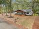 Charming single-story home with inviting covered front porch and a well-manicured, tree-filled front yard at 2205 Stockbridge Se Dr, Atlanta, GA 30316