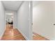 Hallway featuring hardwood floors, white trim, and view to dining room at 2205 Stockbridge Se Dr, Atlanta, GA 30316