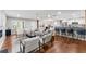 Spacious living area with open kitchen layout, hardwood floors, granite countertops, and stylish counter stools at 2205 Stockbridge Se Dr, Atlanta, GA 30316