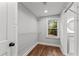 Walk-in closet with custom shelving and hardwood floors, adjacent to bath at 2205 Stockbridge Se Dr, Atlanta, GA 30316
