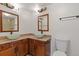 Elegant bathroom with double vessel sinks, granite counters, and wood cabinetry at 3334 Peachtree Ne Rd # 101, Atlanta, GA 30326