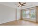 Neutral bedroom with modern ceiling fan, large windows, and light hardwood floors at 3334 Peachtree Ne Rd # 101, Atlanta, GA 30326