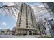An exterior shot of a large building with street signage under a partly cloudy blue sky at 3334 Peachtree Ne Rd # 101, Atlanta, GA 30326
