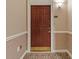 Condo front door with decorative molding, carpet, and patterned wallpaper at 3334 Peachtree Ne Rd # 101, Atlanta, GA 30326