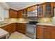 This kitchen features wooden cabinetry, stainless steel appliances, and beautiful granite countertops at 3334 Peachtree Ne Rd # 101, Atlanta, GA 30326