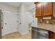 Galley kitchen featuring stainless steel dishwasher, granite countertops, and tile backsplash at 3334 Peachtree Ne Rd # 101, Atlanta, GA 30326