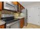 Kitchen with stainless steel appliances, wood cabinets, and tile backsplash at 3334 Peachtree Ne Rd # 101, Atlanta, GA 30326