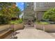 Outdoor retreat featuring a pergola covered dining space surrounded by manicured landscaping and greenery at 3334 Peachtree Ne Rd # 101, Atlanta, GA 30326