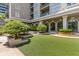 Inviting outdoor area with artificial turf, fountain, beautiful landscaping, and building view at 3334 Peachtree Ne Rd # 101, Atlanta, GA 30326