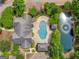 Aerial view showcasing the property's pool, landscaping, pond, and surrounding greenery at 401 Kenley Ct, Mcdonough, GA 30253