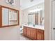 Well-lit bathroom featuring tile floors, wooden cabinets, and a shower-tub combo at 401 Kenley Ct, Mcdonough, GA 30253