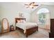 Bright bedroom featuring a bed, neutral walls, vaulted ceiling, and arched window allowing natural light to fill the room at 401 Kenley Ct, Mcdonough, GA 30253