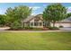 Beautiful home with manicured lawn, lush landscaping, and an attached two-car garage at 401 Kenley Ct, Mcdonough, GA 30253