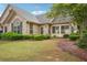 Charming stone home featuring a landscaped front yard, decorative shutters, and well-maintained greenery at 401 Kenley Ct, Mcdonough, GA 30253