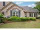 Charming stone home featuring a lovely lawn and well-maintained shrubs at 401 Kenley Ct, Mcdonough, GA 30253