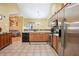 Functional kitchen featuring stainless steel appliances, wooden cabinets, and seamless access to the living area at 401 Kenley Ct, Mcdonough, GA 30253