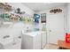 Bright laundry room includes sink, cabinetry, and white front load washer and dryer at 401 Kenley Ct, Mcdonough, GA 30253
