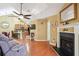Cozy living room featuring a fireplace, vaulted ceilings, hardwood floors, and open floorplan at 401 Kenley Ct, Mcdonough, GA 30253
