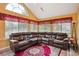 Bright sunroom with tile floors, large windows, and comfortable leather seating area at 401 Kenley Ct, Mcdonough, GA 30253