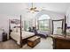 Spacious main bedroom featuring a four-poster bed, vaulted ceilings, and ample natural light at 401 Kenley Ct, Mcdonough, GA 30253