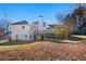 Spacious backyard with a deck and patio perfect for entertaining, surrounded by mature trees and landscaping at 1019 Henna Se Ct, Conyers, GA 30013